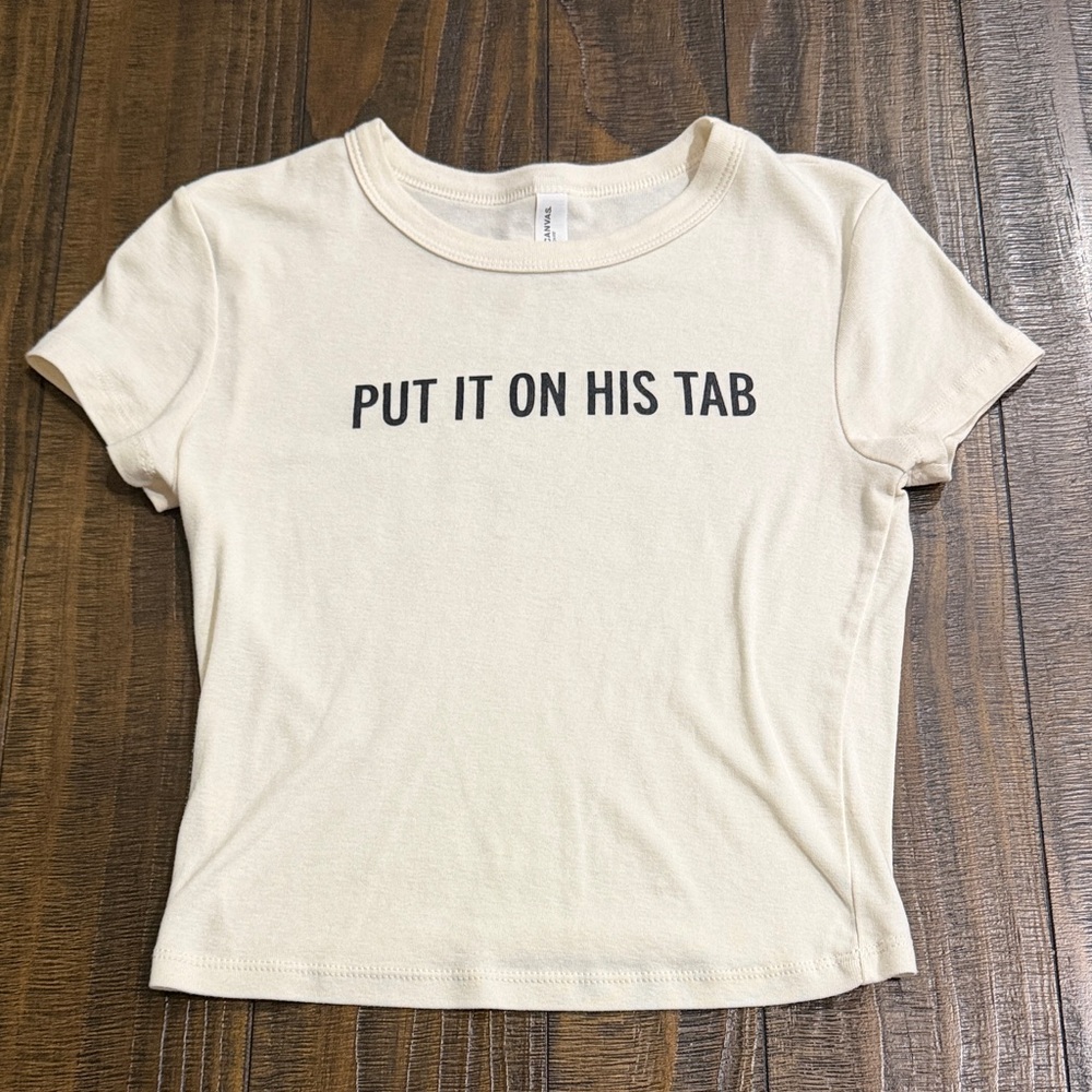 Bella Canvas Cream Crop Top with Black Text - "PUT IT ON HIS TAB"